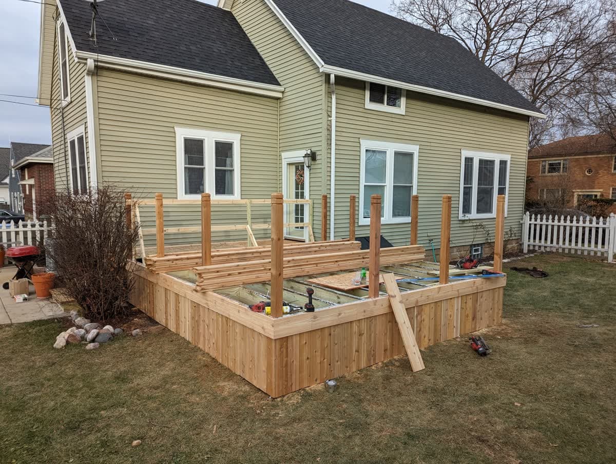 Backyard wood deck with railing and stairs built in the Milwaukee area