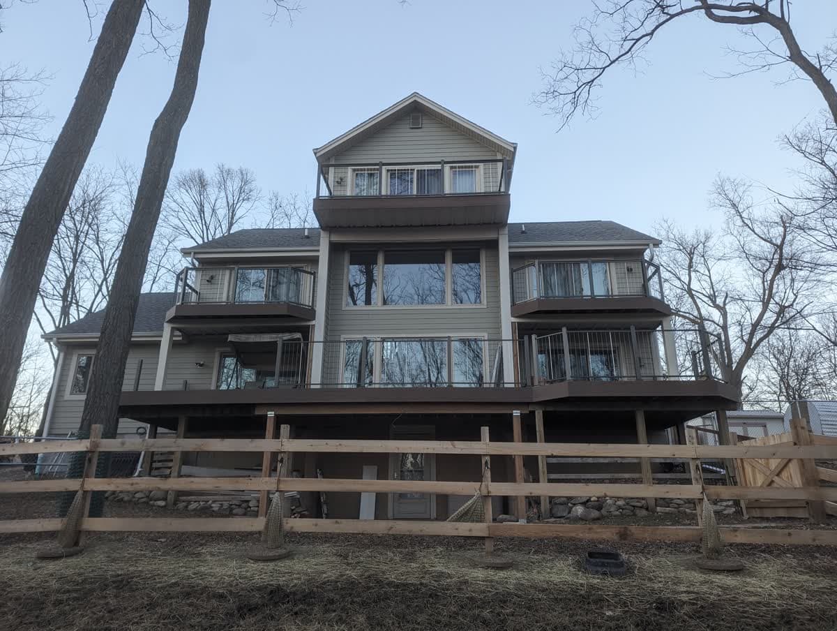 Large multi-level deck spanning the back of a lakeside home in Wisconsin