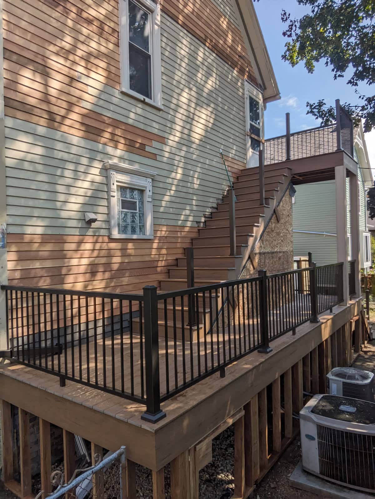 Multi-level wood deck with aluminum railing and stairs in the Milwaukee metro