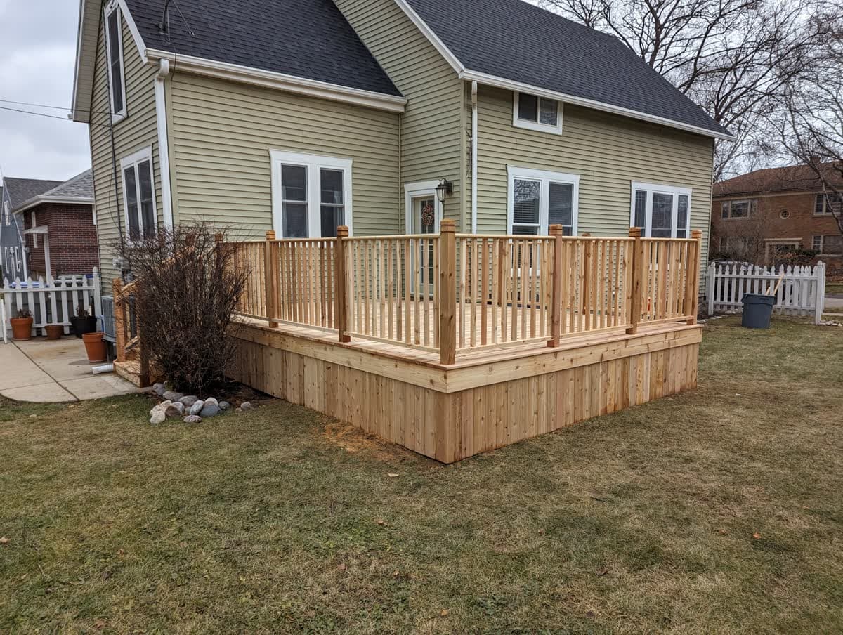 Finished wood deck with wraparound railing on a Southeast Wisconsin home